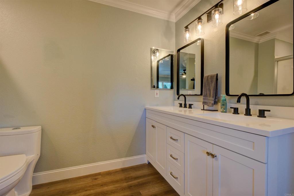 8942 Fletcher Valley Dr. Santee, CA 92071 - Photo 19 of 32 a bathroom with a sink and a mirror