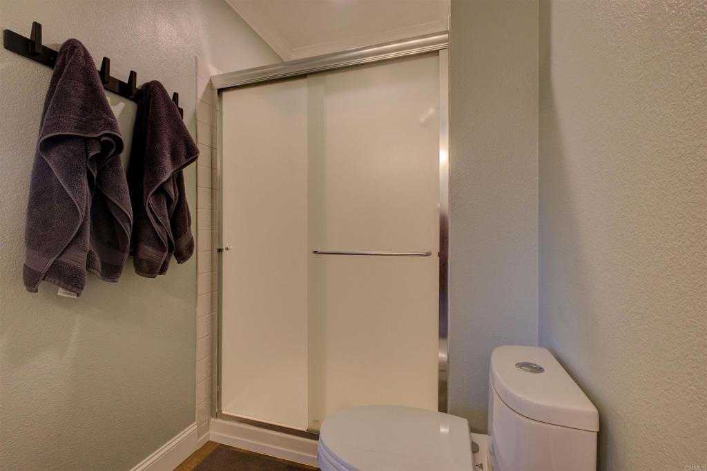 8942 Fletcher Valley Dr. Santee, CA 92071 - Photo 21 of 32 a bathroom that has a toilet and a shower curtain
