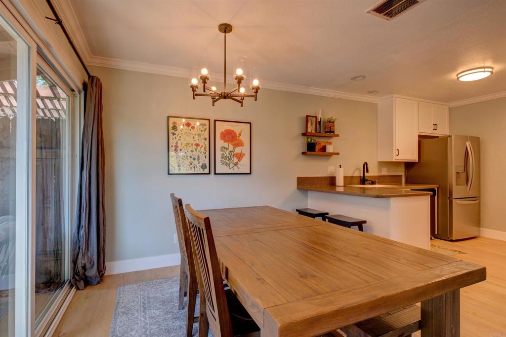 8942 Fletcher Valley Dr. Santee, CA 92071 - Photo 8 of 32 a view of a dining room with furniture and a chandelier