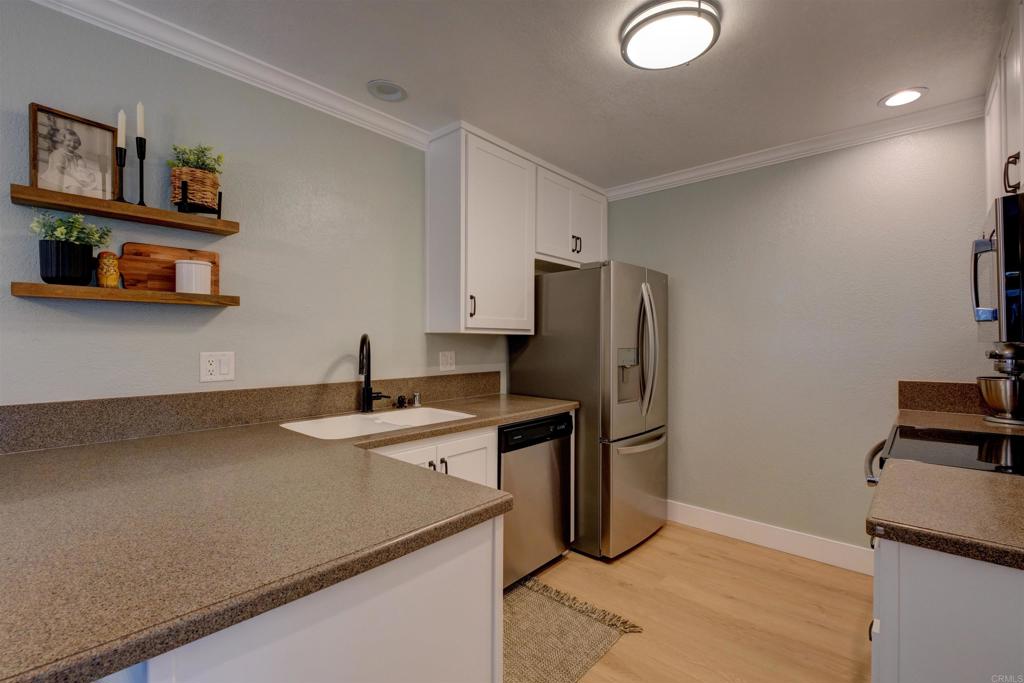 8942 Fletcher Valley Dr. Santee, CA 92071 - Photo 9 of 32 a kitchen with stainless steel appliances granite countertop a refrigerator and a sink