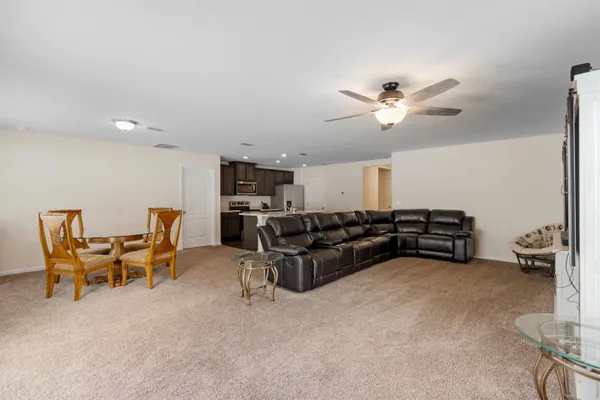 a living room with furniture and a chandelier