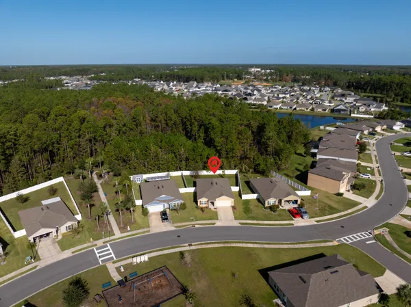 an aerial view of a house with a ocean view