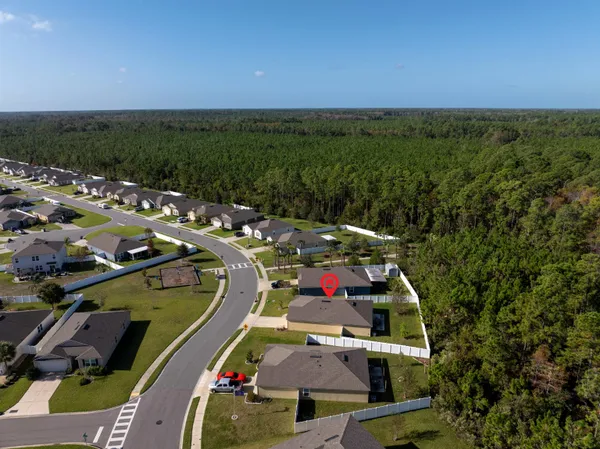 an aerial view of a houses with a swimming pool