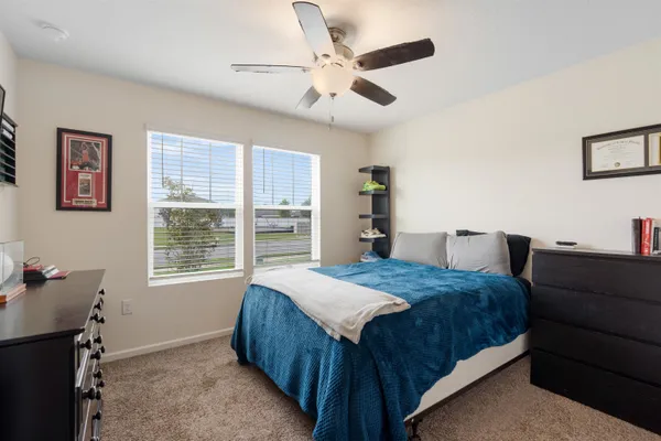 a bedroom with a bed and a window