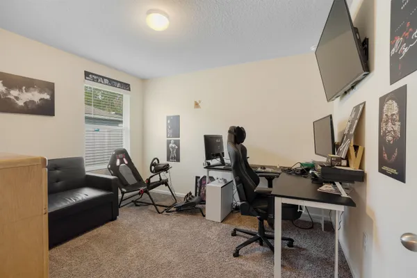 a living room with furniture a flat screen tv and a window