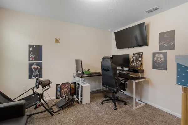 a view of a workspace with furniture and a flat screen tv