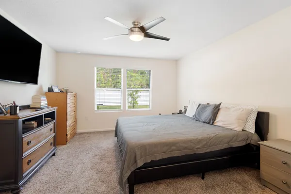 a bedroom with a bed and a flat screen tv