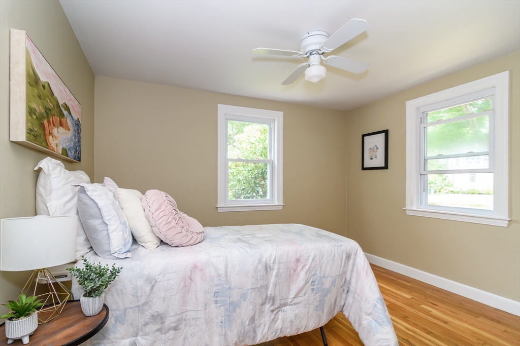7 Ferndale Road Natick, MA 01760 - Photo 11 of 20 a bedroom with a large bed and a chandelier