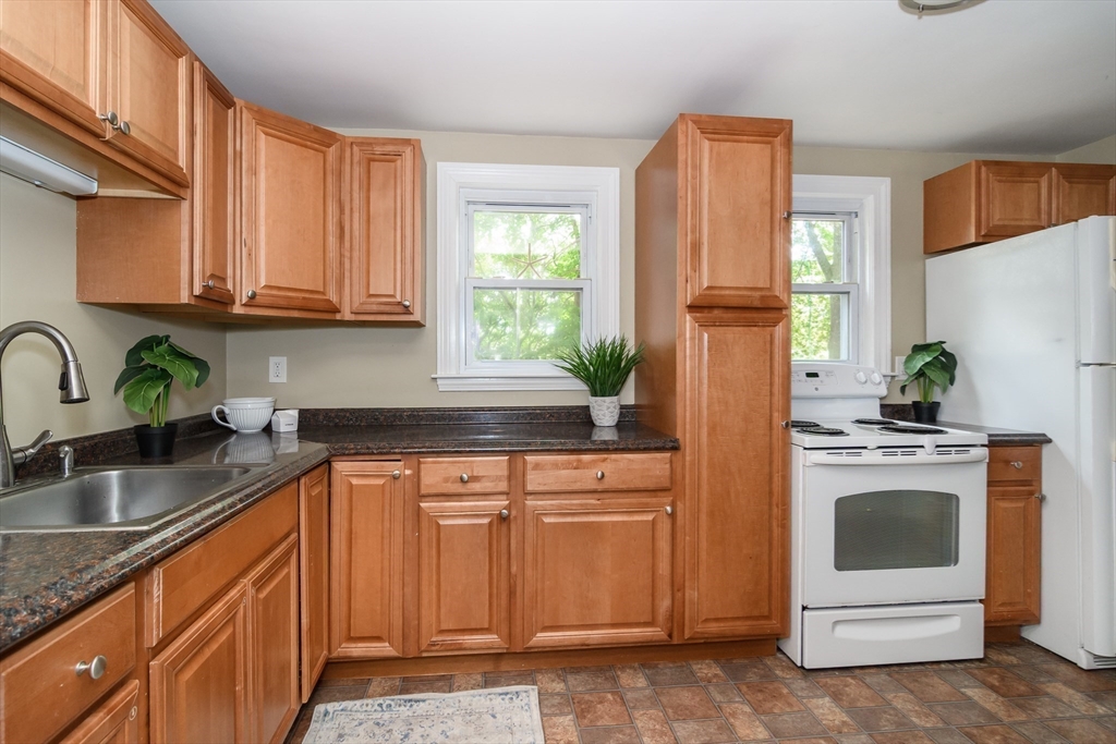 7 Ferndale Road Natick, MA 01760 - Photo 7 of 20 a kitchen with granite countertop a refrigerator sink stove and microwave