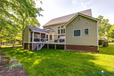 a view of a house with a yard and sitting area