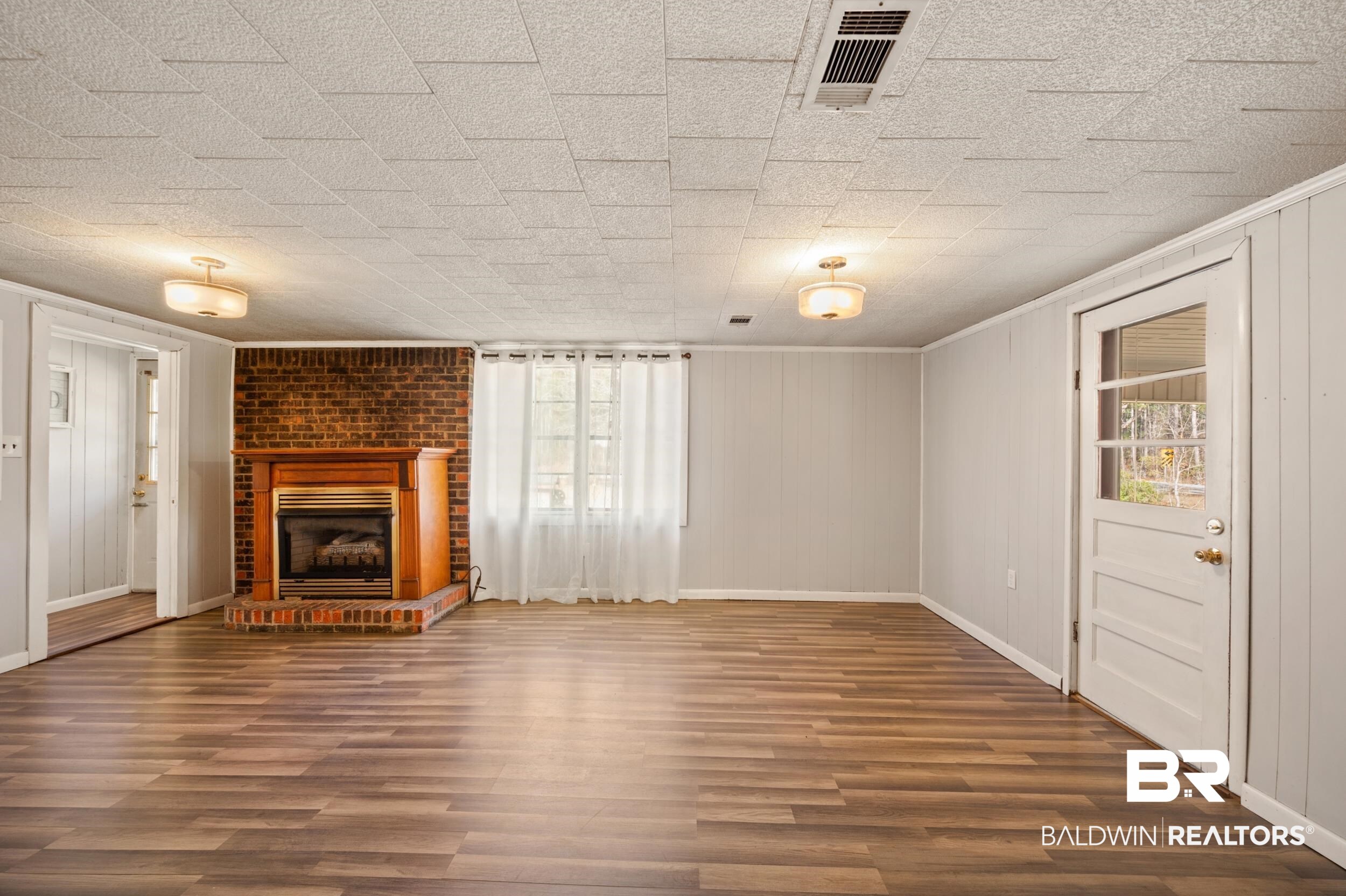 57623 Mary Hadley Road Perdido, AL 36562 - Photo 9 of 34 Unfurnished living room featuring dark wood finished floors and a fireplace