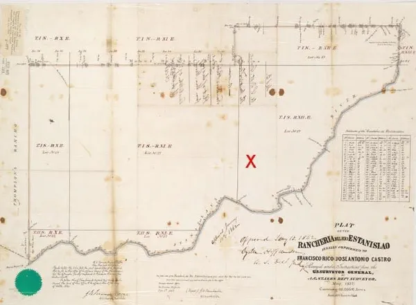 a view of wooden floor with a white wall and a picture of the bathroom