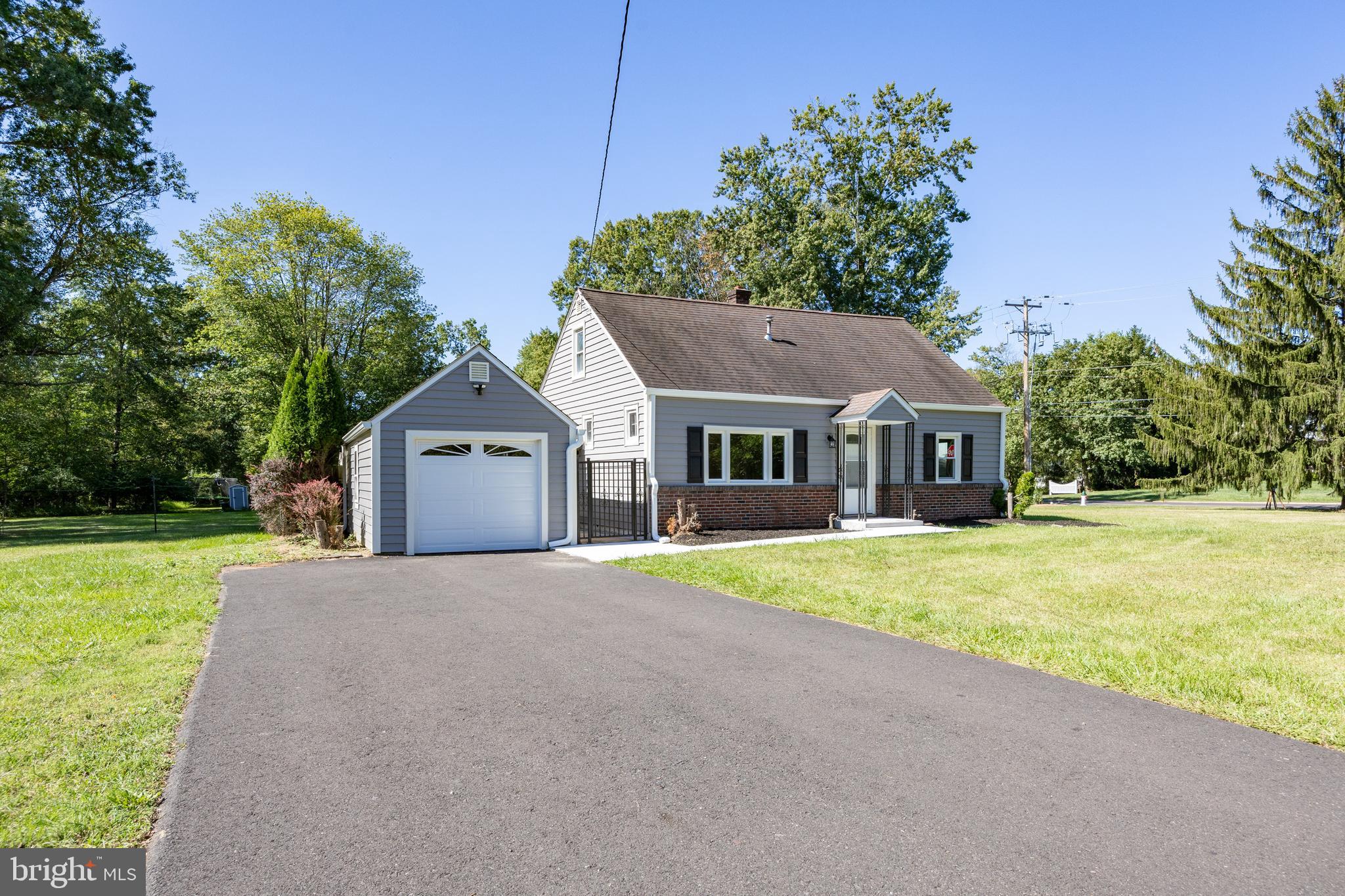 2405 Line Lexington Road Hatfield, PA 19440 - Photo 4 of 31 a front view of a house with a yard and garage