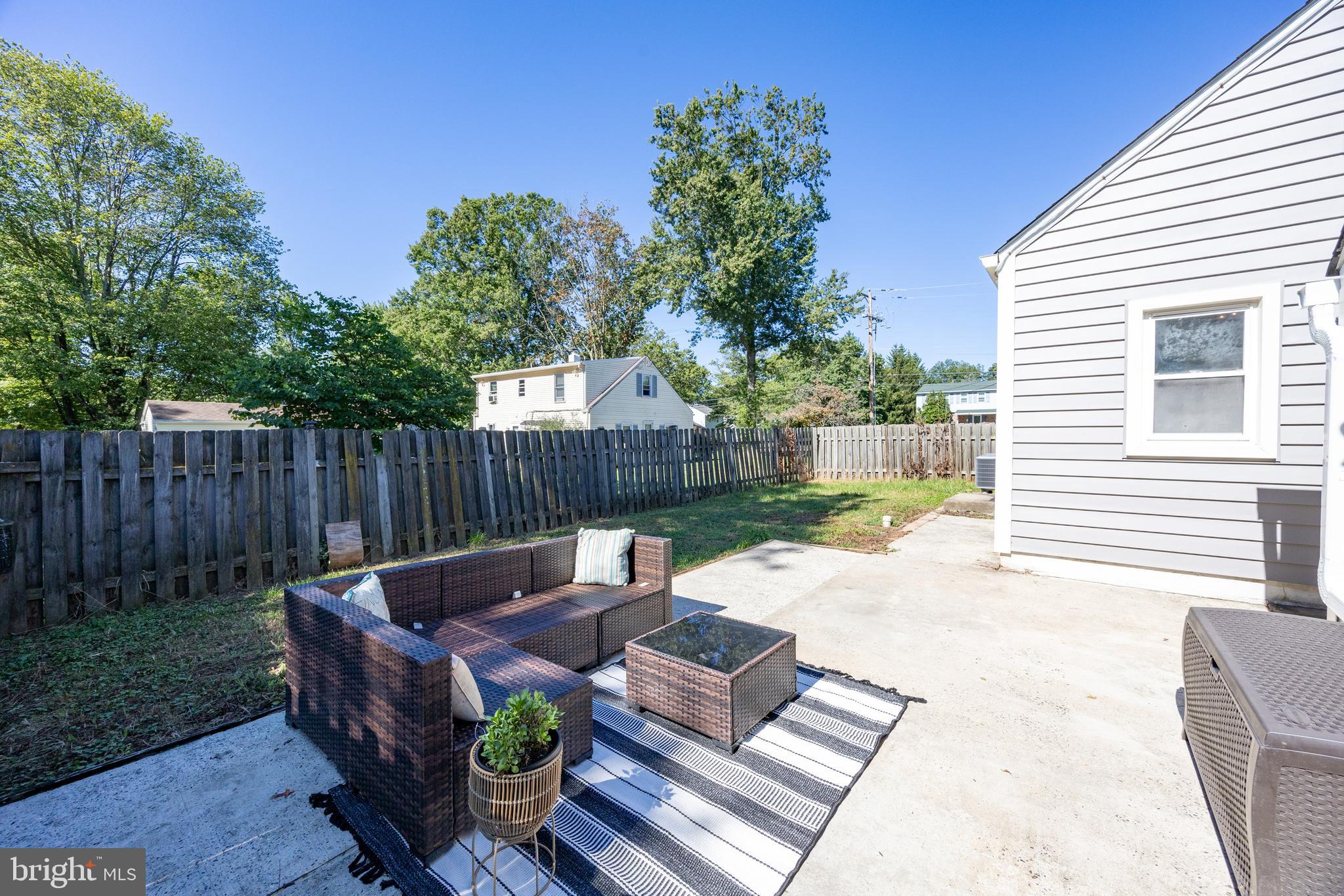 2405 Line Lexington Road Hatfield, PA 19440 - Photo 10 of 31 a view of a backyard with table and chairs potted plants and wooden fence