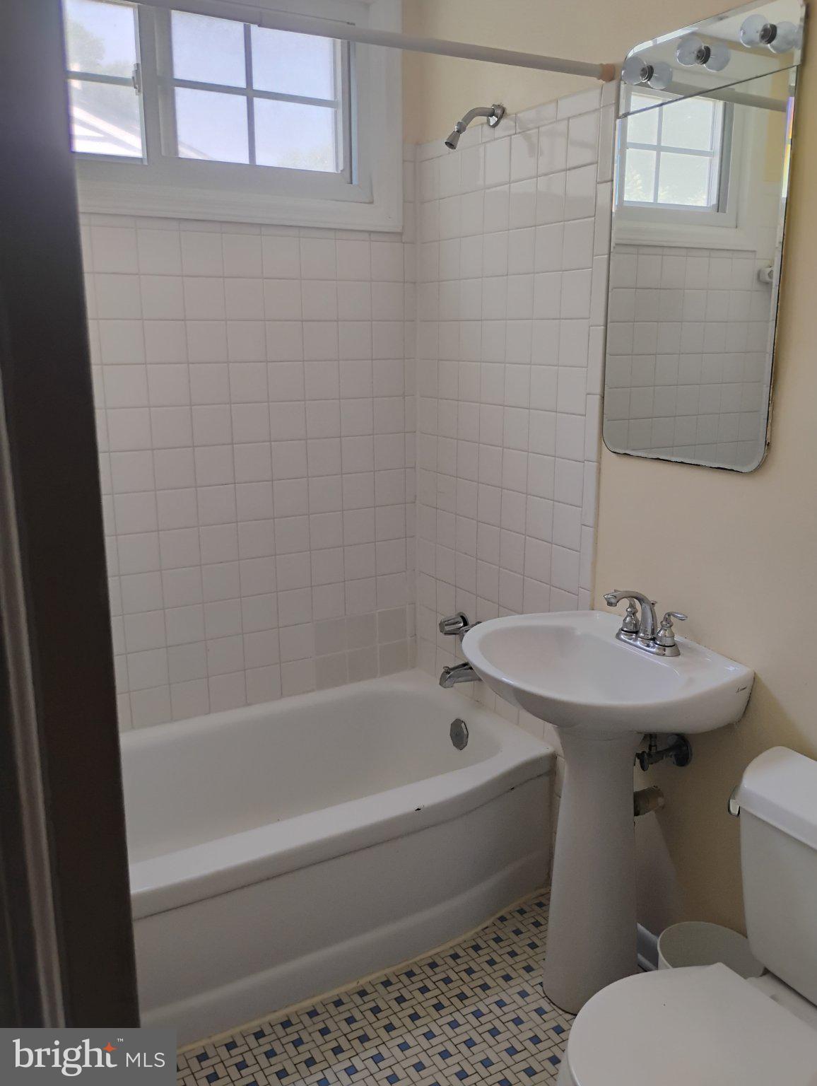 3908 Lantern Drive Silver Spring, MD 20902 - Photo 8 of 15 a bathroom with a sink toilet and shower