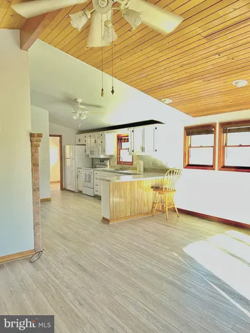 a view of kitchen with furniture and wooden floor