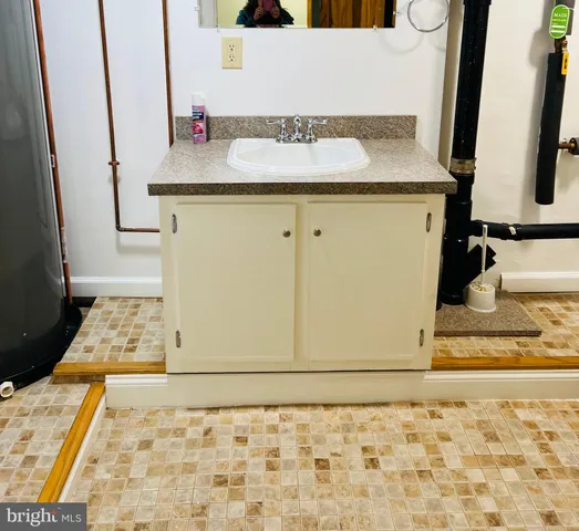 a bathroom with a sink a toilet and a mirror