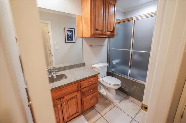 a spacious bedroom with a balcony a bed and ceiling fan