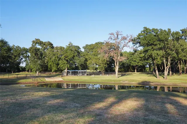 a view of a yard with wooden fence
