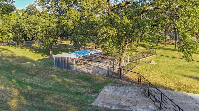 a front view of a house with yard and green space