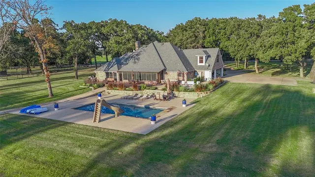 an aerial view of a house with a yard
