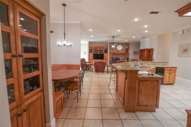 a large kitchen with stainless steel appliances granite countertop a sink and cabinets