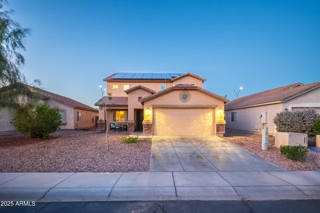 a view of a house with a yard and garage