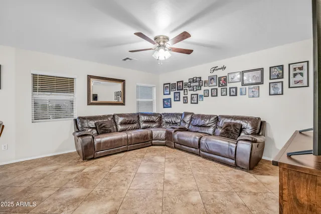 a living room with furniture and wall painting