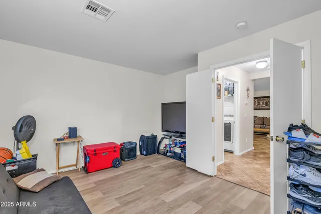 a bedroom with furniture and a flat screen tv