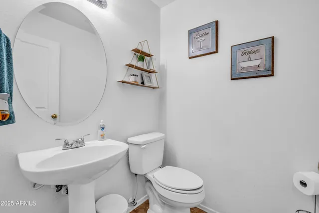 a white toilet sitting next to a bathroom sink