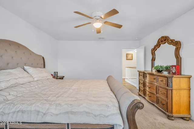 a bedroom with a bed dresser and a window