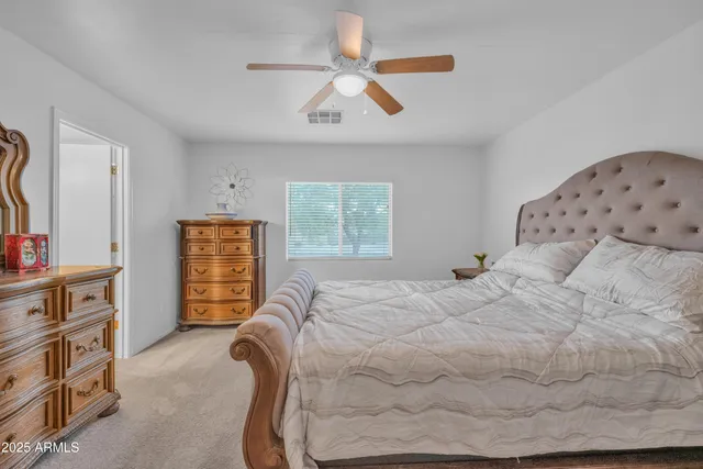 a bedroom with a bed and a television