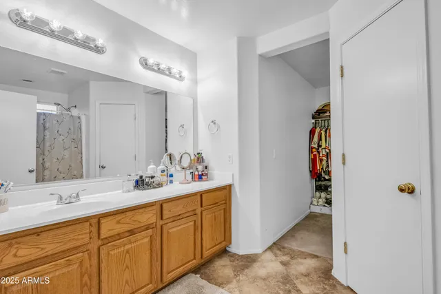 a bathroom with a double vanity sink and a mirror