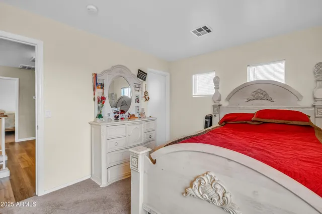 a bedroom with a bed and a dresser in it