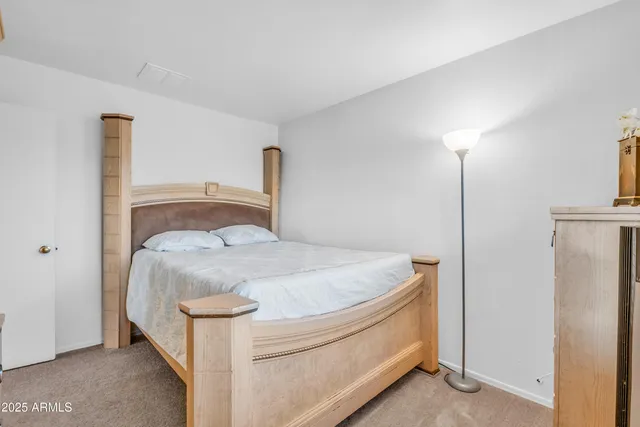 a bedroom with a bed and a night stand