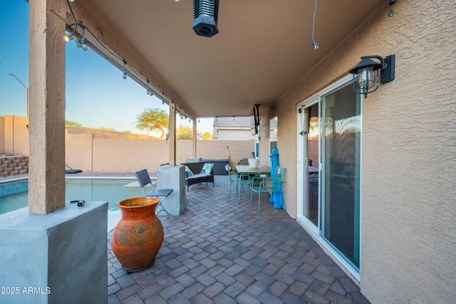 a dining room with furniture and a floor to ceiling window