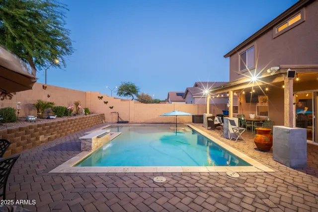 swimming pool view with a outdoor seating