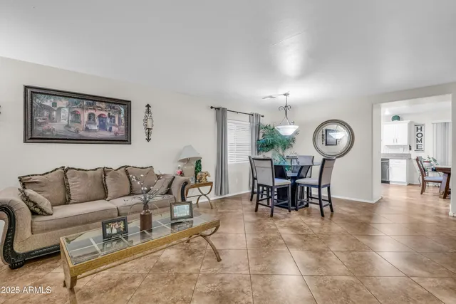 a living room with furniture a clock and a window