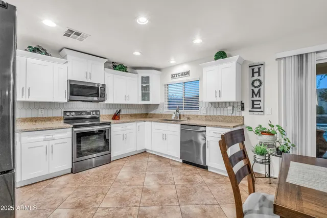 a kitchen with a stove a sink and a microwave