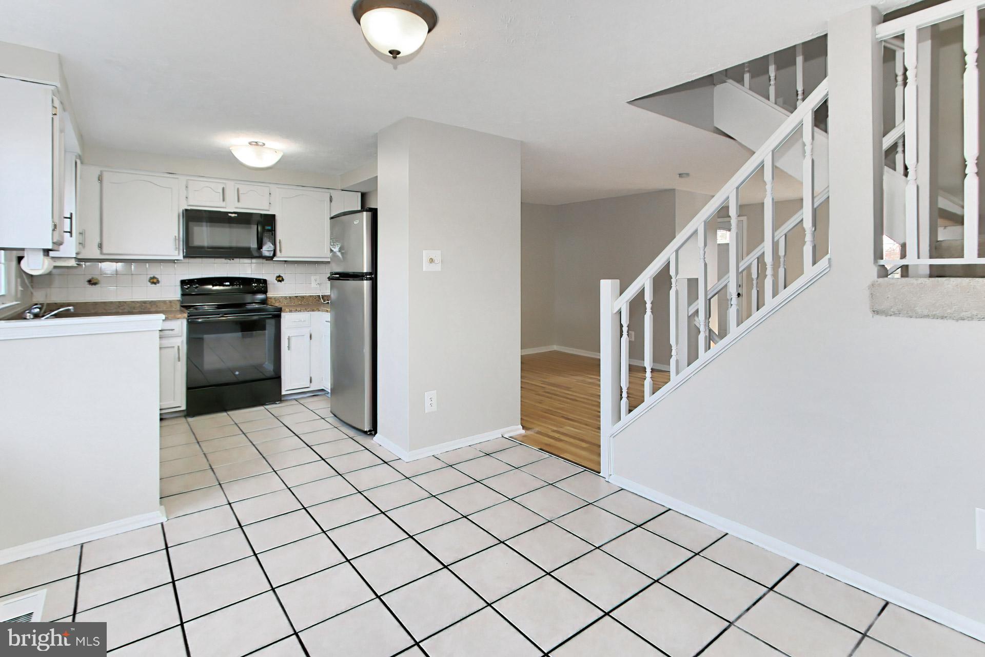 7406 Aspenpark Road Lorton, VA 22079 - Photo 10 of 33 Tiled kitchen + dining span entire width of TH