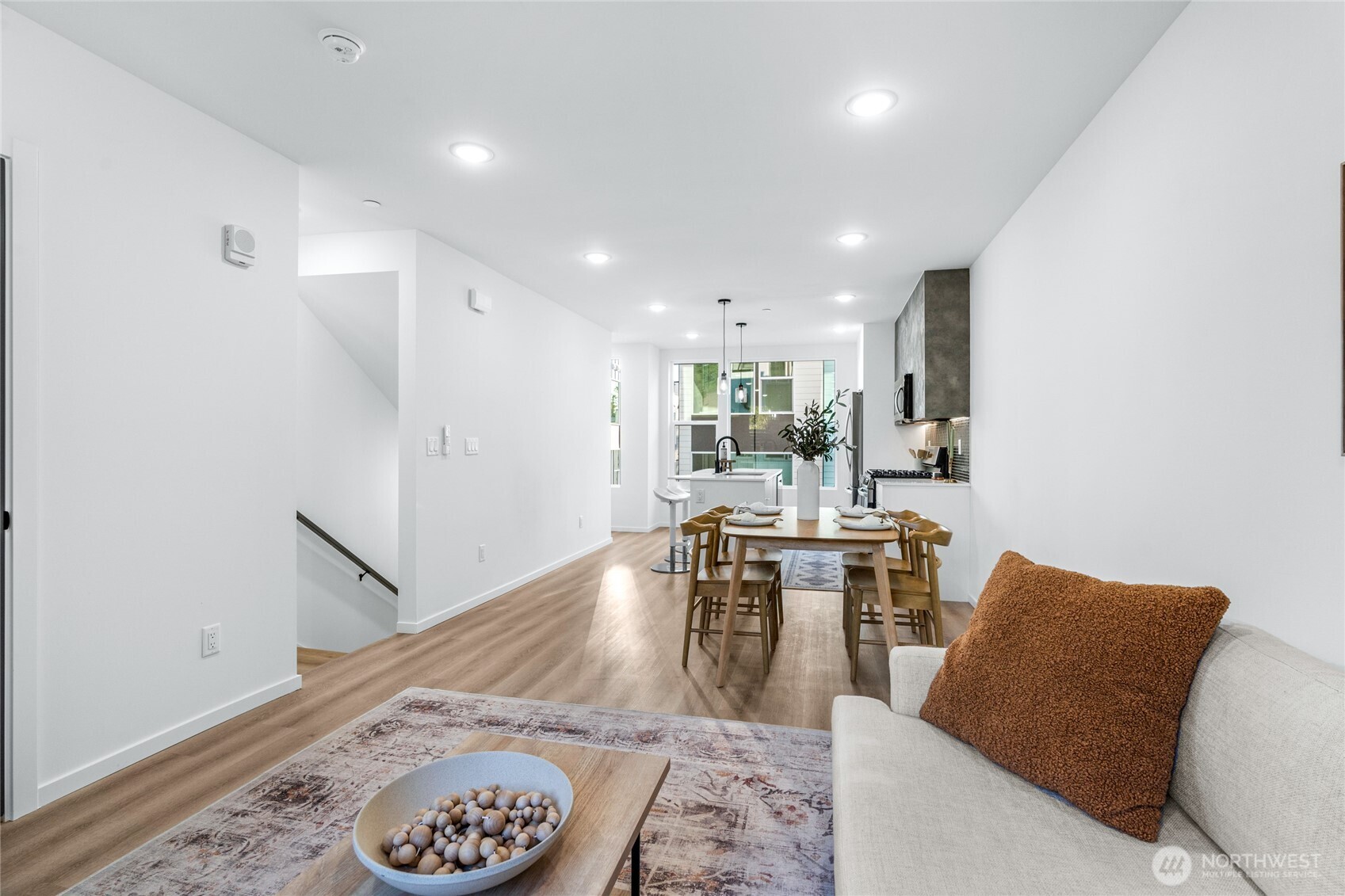 3510 Northeast 125th Street, Unit F Seattle, WA 98125 - Photo 11 of 24 a living room with furniture and a wooden floor