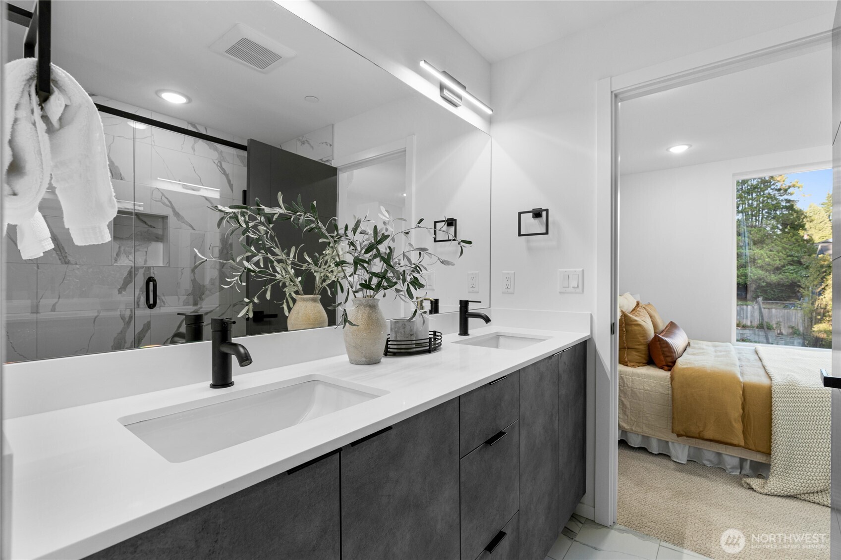 3510 Northeast 125th Street, Unit F Seattle, WA 98125 - Photo 22 of 24 a bathroom with double vanity sinks a mirror and shower