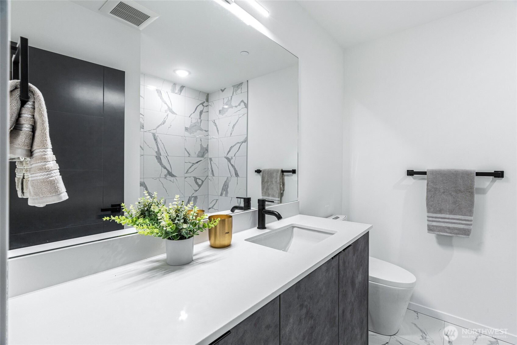 3510 Northeast 125th Street, Unit F Seattle, WA 98125 - Photo 7 of 24 a bathroom with a sink a toilet and shower