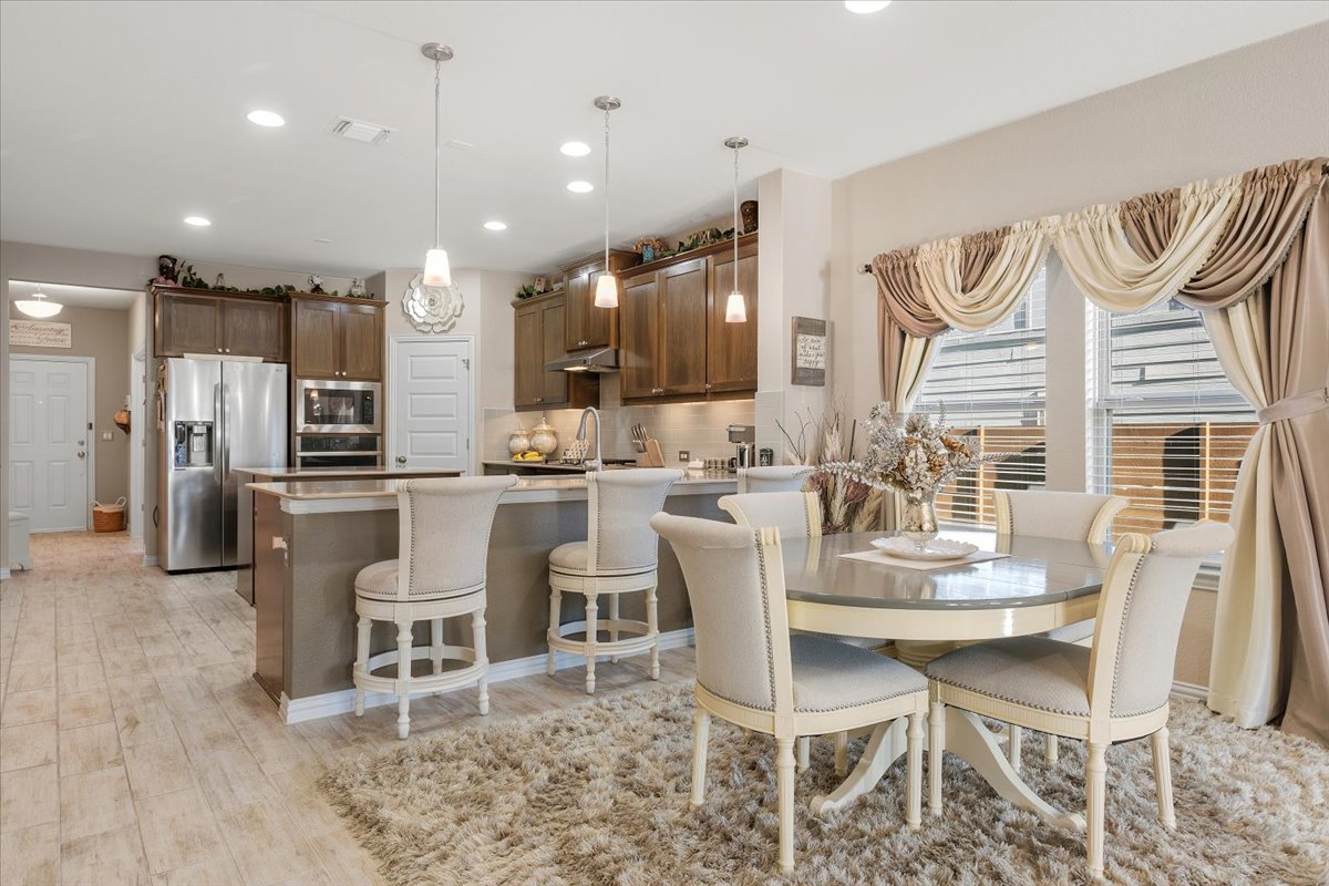 8721 Sikes Way Austin, TX 78747 - Photo 10 of 37 a dining room with furniture and a kitchen view