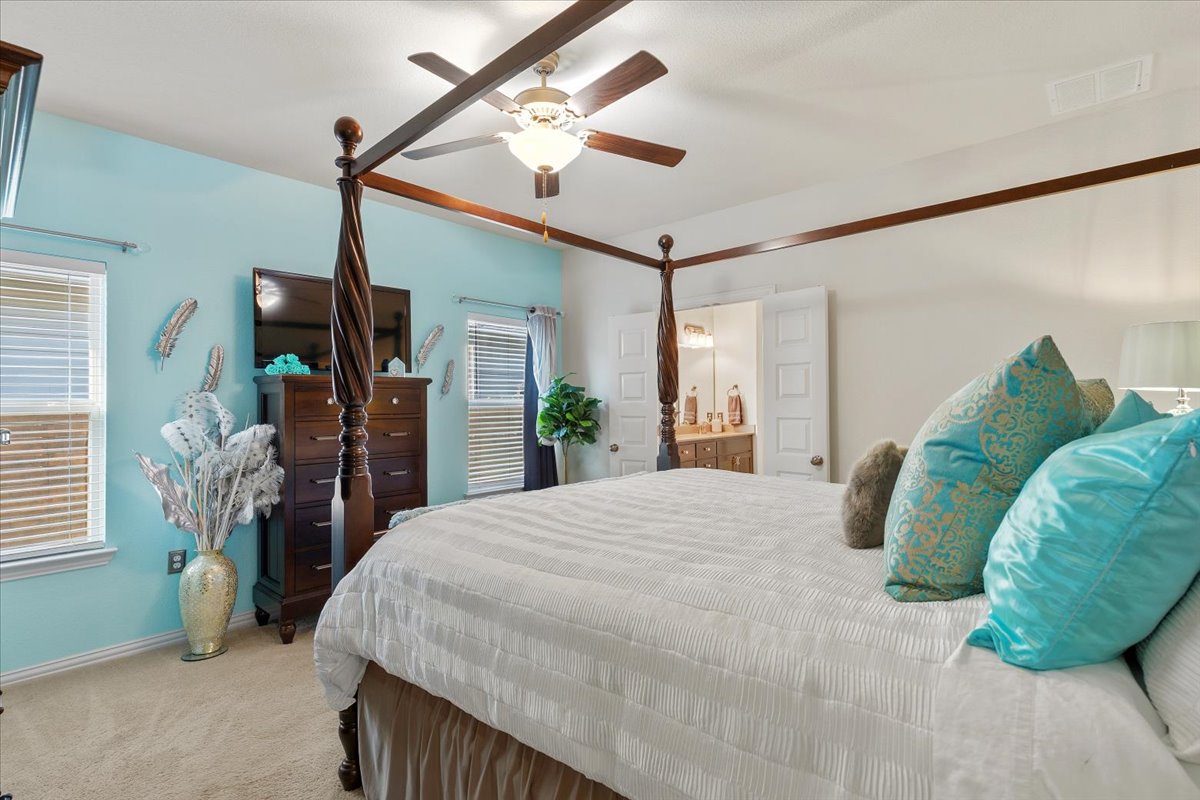 8721 Sikes Way Austin, TX 78747 - Photo 15 of 37 a bedroom with a bed window and a ceiling fan