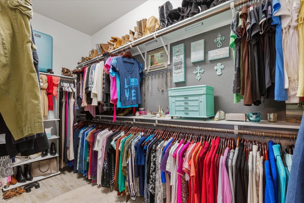 8721 Sikes Way Austin, TX 78747 - Photo 22 of 37 a view of walk in closet with clothes