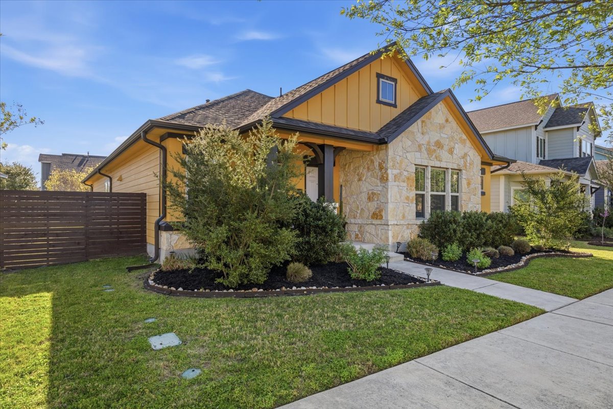 8721 Sikes Way Austin, TX 78747 - Photo 4 of 37 a front view of a house with a yard