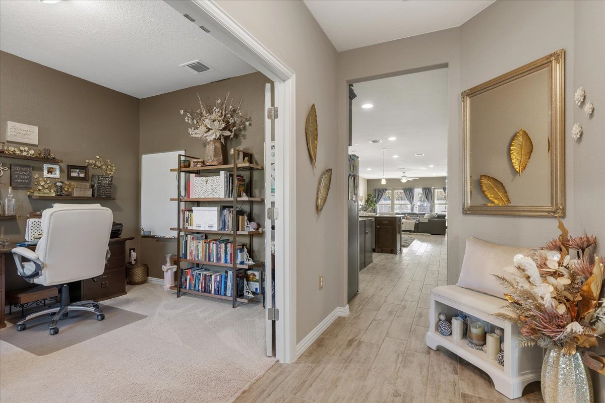 8721 Sikes Way Austin, TX 78747 - Photo 7 of 37 a view of a workspace with furniture and a book shelf