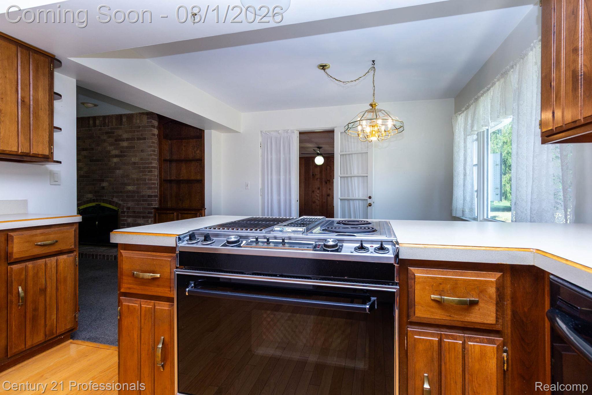 1365 East Buell Road Rochester, MI 48306 - Photo 14 of 56 Kitchen featuring wood cabinetry, solid surface countertops, and an integrated cooktop and oven