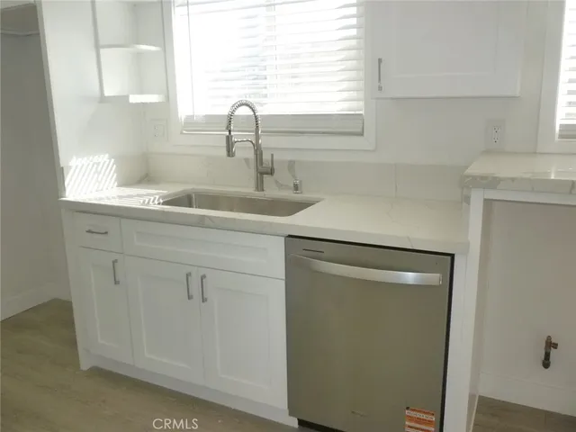 a stove top oven sitting inside of a kitchen